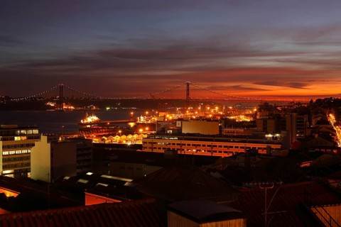 View from Miradouro de Santa Catania on the Bairro Alto and Ponte 25 de Abril at dusk