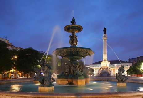 Bronze fountain monument Pedro IV. on Rossio square at dusk