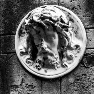 Face of Jesus on a gravestone in the cemetery next to the ghost church of Lukova