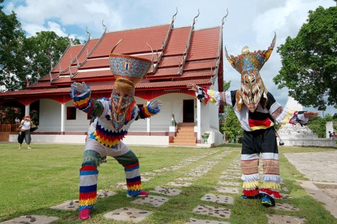 People dressed up with ghost masks and colourful costumes