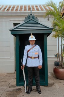 A soldier of the Royal Guards stands at the entrance of the Grand Palace
