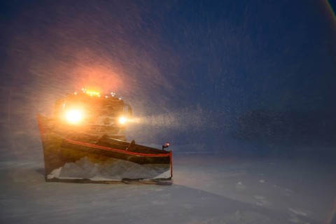 Snowplow in the arctic blizzard during the polar night