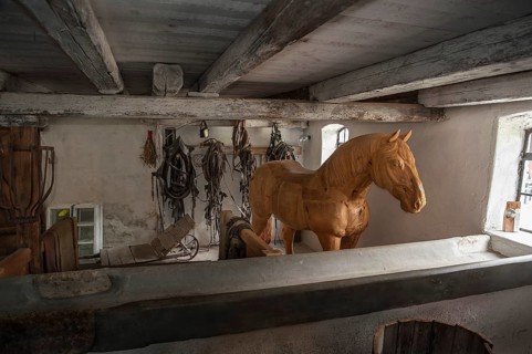 Wooden horse in the horse barn