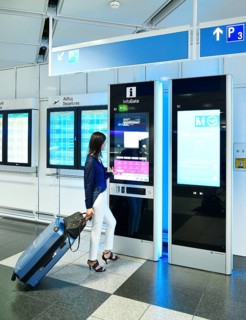 Woman with luggage at the InfoGate