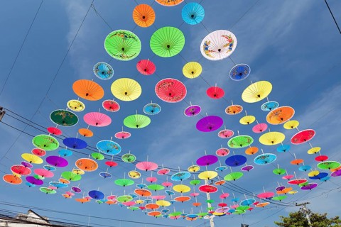 Many colourful umbrellas suspended in mid-air