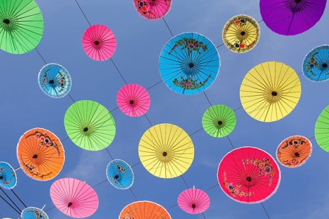 Many colourful umbrellas suspended in mid-air