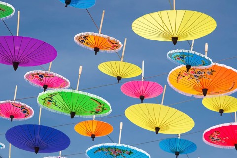 Many colourful umbrellas suspended in mid-air