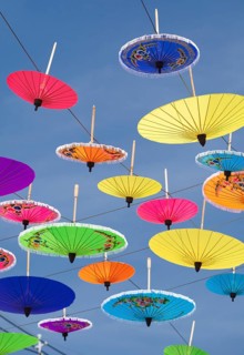 Many colourful umbrellas suspended in mid-air