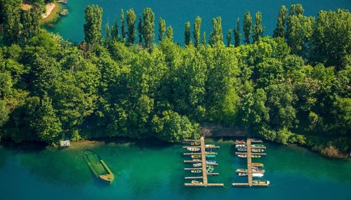 Escher lake with boats docked at a pier