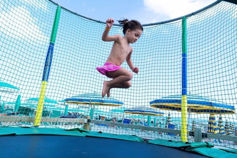 Kid jumping on a trampoline