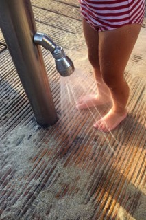 Girl washing sand off her feet