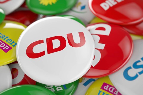 German political party CDU button in front between other governing party buttons