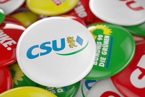 German political party CSU button in front between other governing party buttons