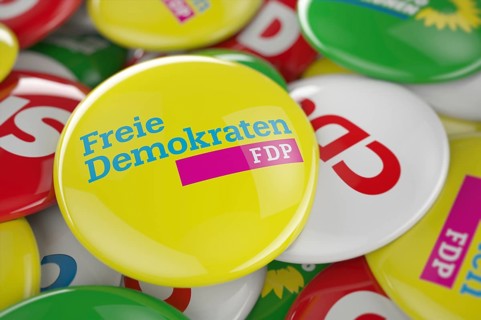 German political party FDP button in front between other governing party buttons
