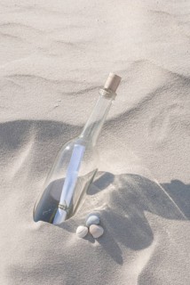 Bottle with a message inside on a sandy beach