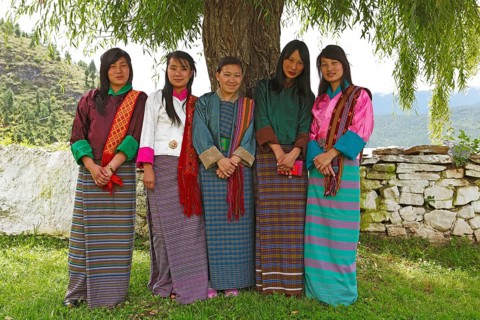 Young women wearing colorful Kira dresses