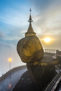 Golden Rock with Kyaiktiyo Pagoda in fog and sunset