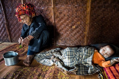 Old woman and sleeping child with thanaka paste in the face of hill tribe Pa-O or Pa-Oh or Pao or Black Karen or Taungthu or dew-soo