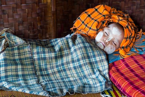 Sleeping child with Thanaka paste on the face