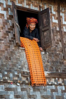 Old woman looking out of a lodge window