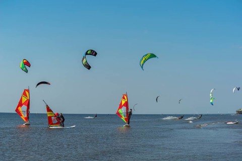 Kitesurfers and windsurfers