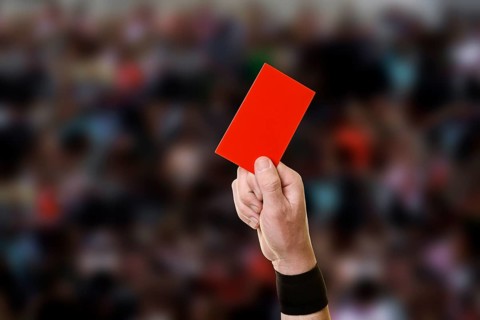 Referee showing a red card during a football game
