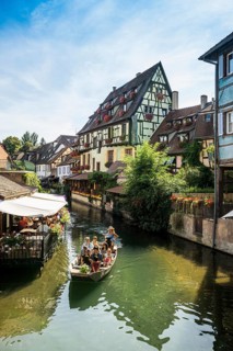Timbered houses and canal with excursion boat
