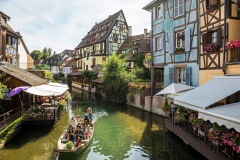 Timbered houses and canal with excursion boat