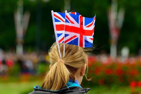 Female fan of the Queen with Union Jack flags on her head