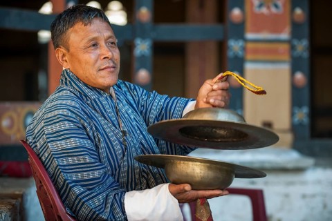 A man with cymbals at a temple festival