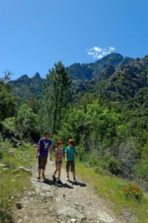 Hikers at the Cirque de Bonifatu Boucle de Ficaghiola at the long-distance trail Tra Mare e Monti and GR20