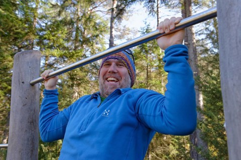 Man doing pull-ups on a bar