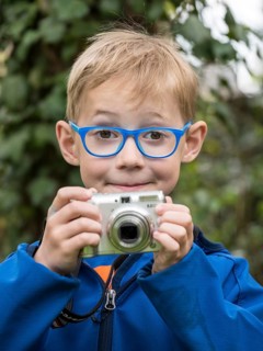 Boy with compact camera