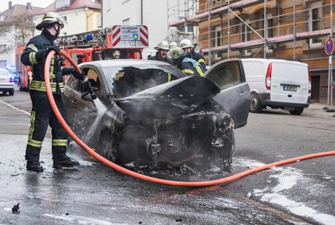Fire department extinguishing a burning Corsa