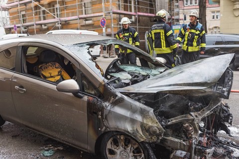 Fire department extinguishing a burning Corsa