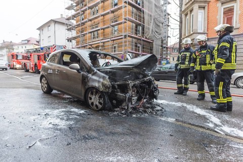 Fire department extinguishing a burning Corsa