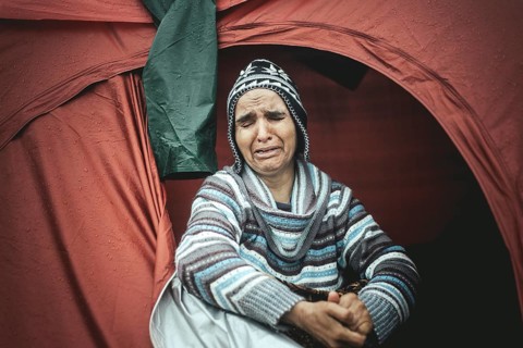 Desperate woman from Afghanistan weeping in her tent