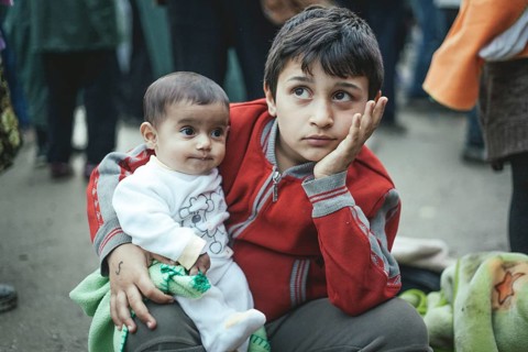 Boy from Syria after arriving with his little brother
