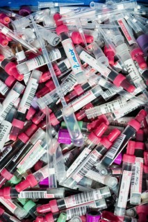 Transparent monovettes containing different blood samples in a garbage bin