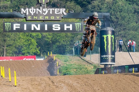 Motorcyclist on a motocross bike jumping through the air