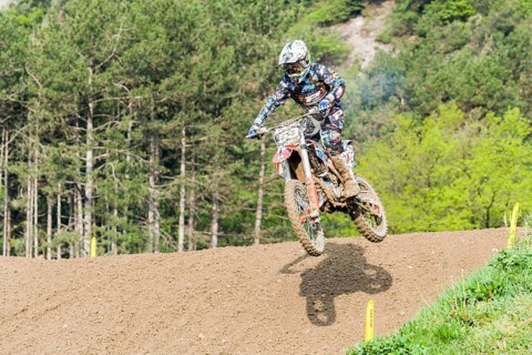 Motorcyclist on a motocross bike jumping through the air