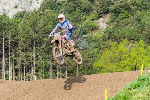 Motorcyclist on a motocross bike jumping through the air
