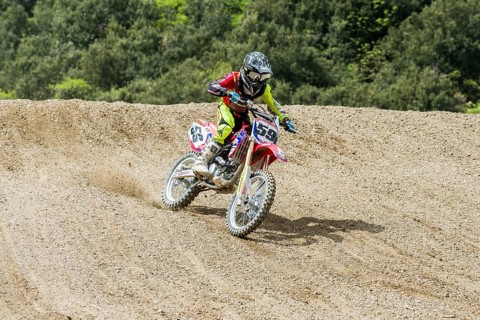 Motorcyclist on a motocross bike riding on a dirt track
