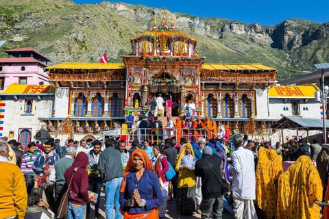 Many pilgrims are gathering in front of the colourful Badrinath Temple