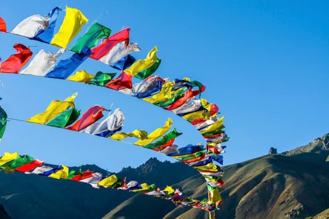 Tibetan prayer flags waving in the wind at Lamayuru Gompa