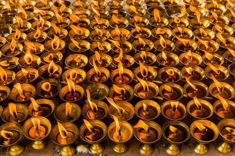 Many butter lamps are lightened at a temple in Boudha