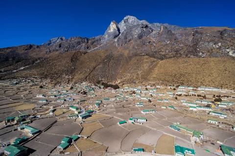 Spread out agricultural village with fields and farmers houses in a high valley