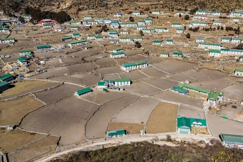 Spread out agricultural village with fields and farmers houses in a high valley