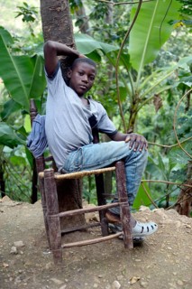 Teenager boy on a rickety chair