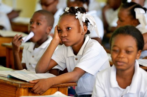 Schoolgirl with sullen facial expression during class